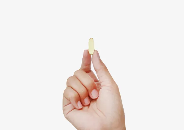 淡黄色治愈手捏着的西药片实物免抠