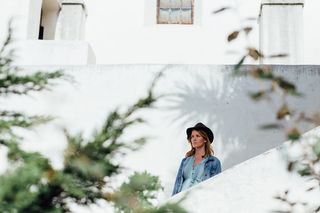 白天站在白墙旁边的女人