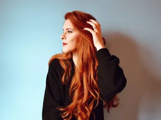 一名身穿黑色夹克的女子从右侧看去