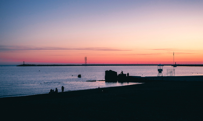 海边的剪影，一群人在水面前
