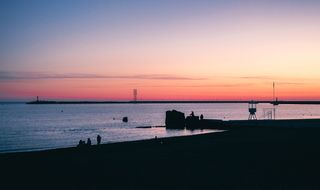 海边的剪影，一群人在水面前