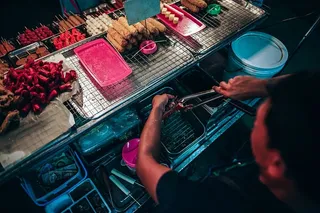 拿着灰色不锈钢夹子的男子