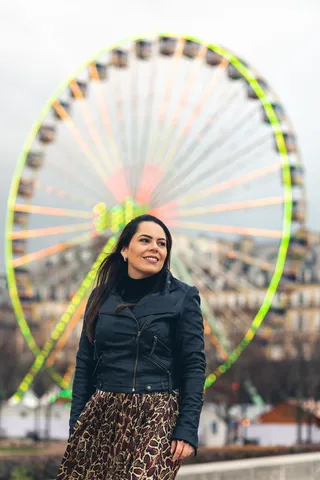 站在摩天轮旁微笑的女人