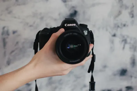 拿着黑色佳能 EOS 6D 的人 拿着黑色佳能 EOS 6D 的人