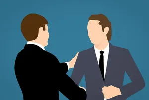 两名男子在面试或商务会议后握手的图示。商业环境。