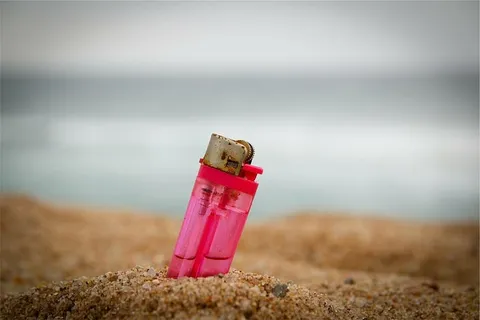 粉色,一次性,打火机,埋地,沙子,棕色,无人,白天 粉色,一次性,打火机,埋地,沙子,棕色,无人,白天