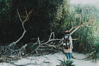 背着背包的女人站在树旁