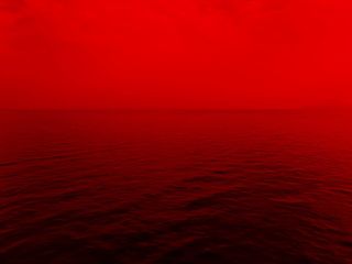 红色灯光下的海洋照片