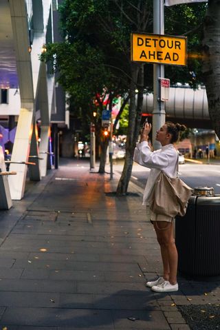 在人行道上拍照的女人