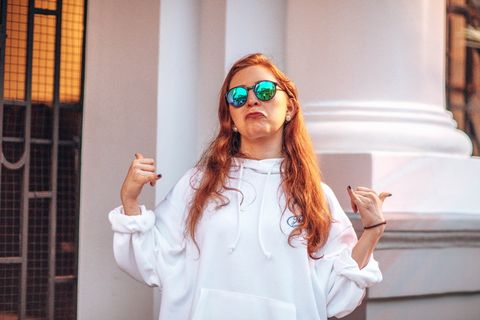 穿着套头衫连帽衫和太阳镜的女士