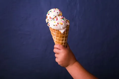 拿着棕色冰淇淋筒和草莓冰淇淋的孩子们 拿着棕色冰淇淋筒和草莓冰淇淋的孩子们
