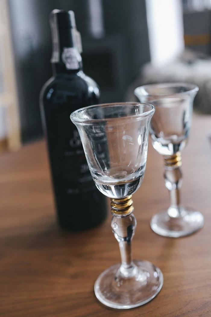 桌子上放着两个空酒杯和一瓶葡萄酒
