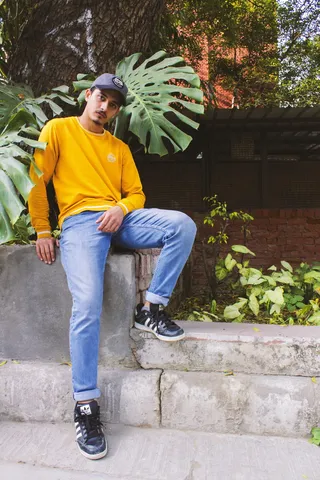 穿黄色圆领毛衣的男子