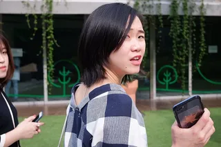 手持黑色智能手机的女子