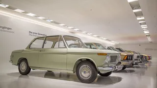 停在汽车旁的灰色双门轿车