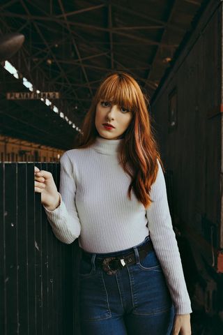 穿着灰色运动衫和蓝色牛仔的女人