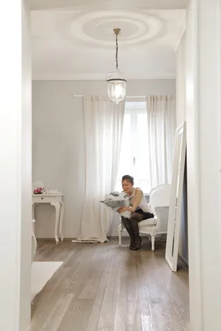 坐在白色椅子上拿着鲜花的女人