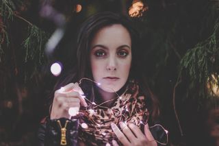 拿着白色细绳灯的女人