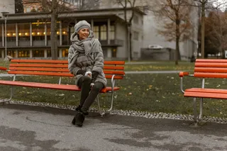 坐在公园长椅上的女子照片