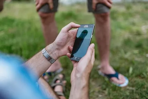 男子手在手机上玩电子游戏的特写镜头