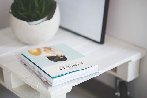 小木桌，一盆植物和一个灰色钱包