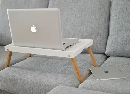 沙发上笔记本电脑桌上的银色MacBook 沙发上笔记本电脑桌上的银色MacBook