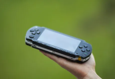 手持黑色索尼Psp手持控制台的人的特写照片