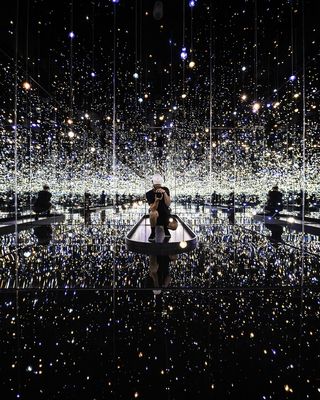 被灯光包围时，一名男子在镜子上拍照