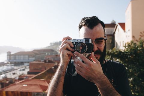 男子手持灰点并拍摄摄像机