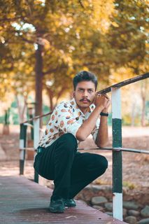 男子在金属栏杆旁摆姿势