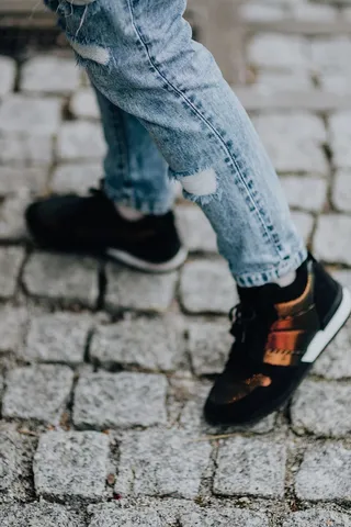 穿着黑色运动鞋和蓝色牛仔裤的女人