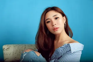 Woman Sitting on Chair While Hugging Her Knees