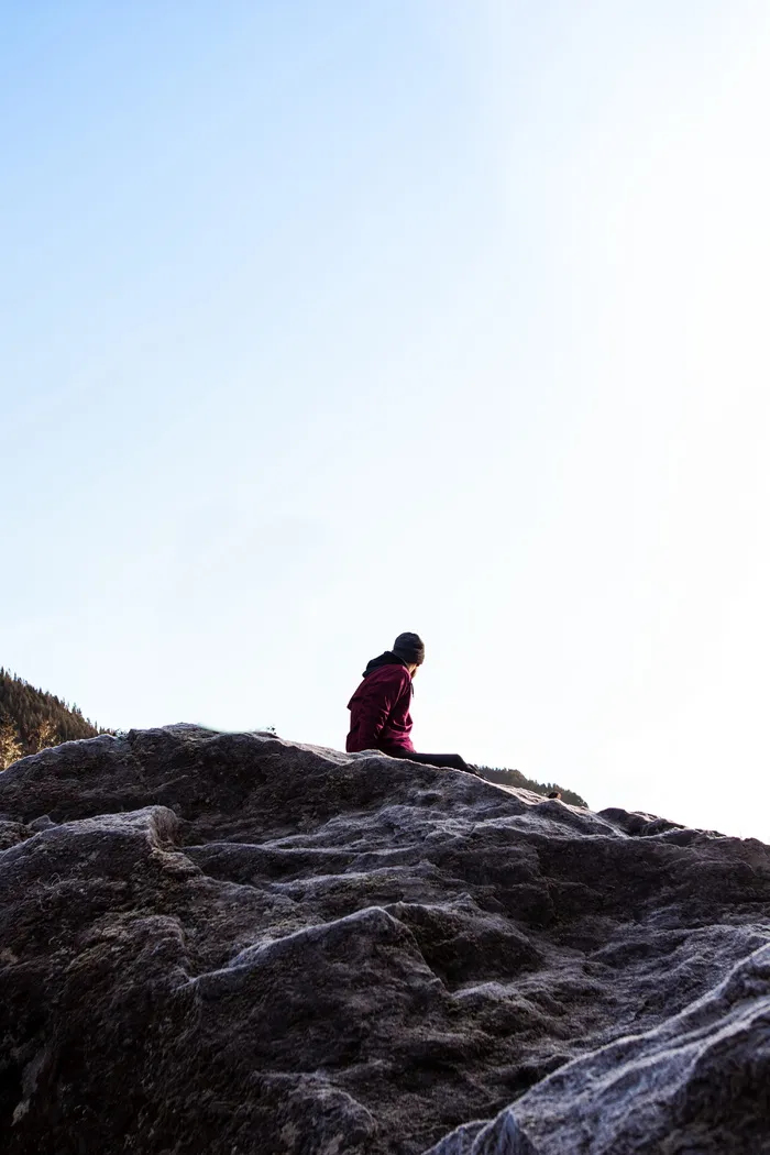 坐在灰色岩石山上的人