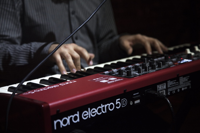 玩红色和黑色Nord Electro 5d键盘的人