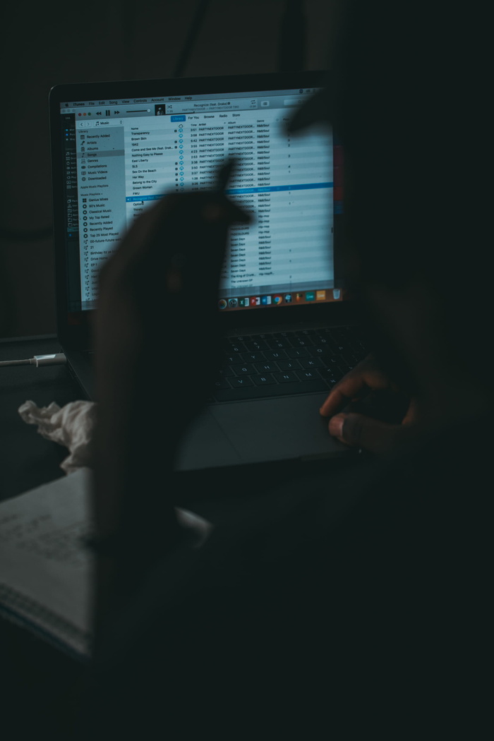 带iTunes显示屏的开放式MacBook Pro人性化剪影摄影