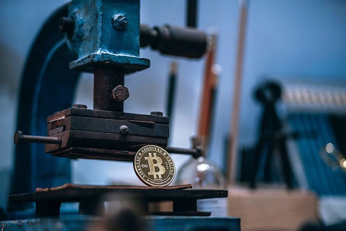 工匠机器上闪亮的镀金比特币。比特币值多少钱？