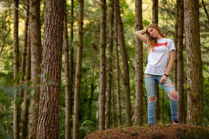 Woman Wearing White Shirt Taking Pose Near Brown Trees