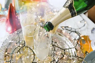 庆典把香槟倒进杯子里。新年快乐！