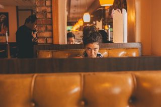 坐在建筑物内长椅中间的女性的选择性聚焦摄影