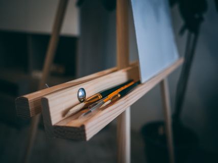 棕色画架,带钢笔和画笔 棕色画架,带钢笔和画笔