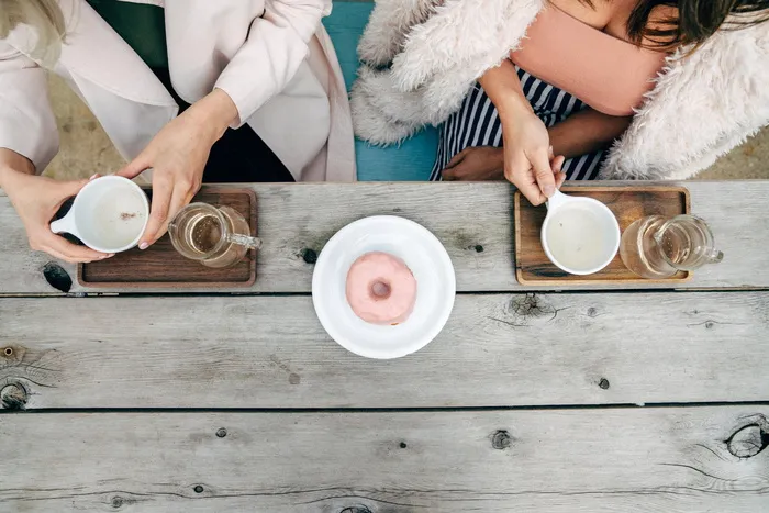 两个女人在桌子旁喝茶