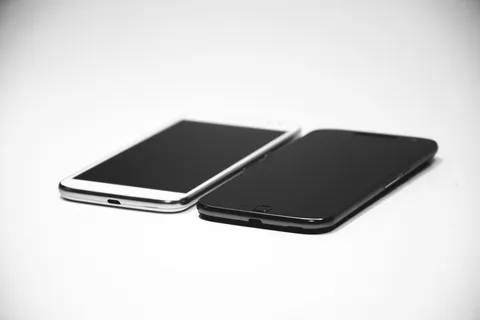 白色Android智能手机靠近黑色Android智能手机 白色Android智能手机靠近黑色Android智能手机