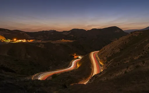 road beside mountain during golden hour road beside mountain during golden hour