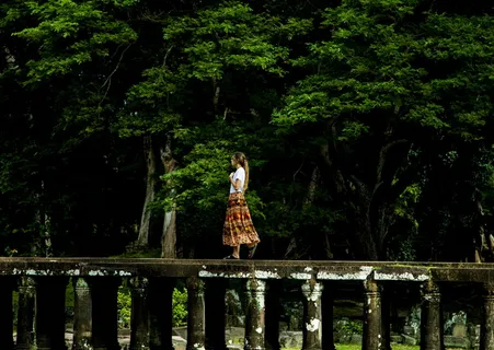 走在树环绕的桥上的女人 走在树环绕的桥上的女人