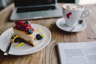 在餐厅工作：Macbook、奶酪蛋糕和一杯咖啡