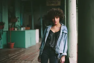 靠着白色柱子的女人