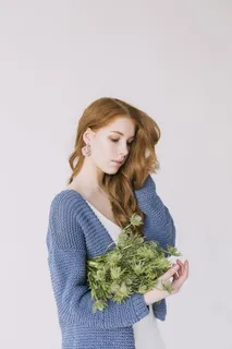 身穿蓝色开衫、手持绿色花朵的女子 身穿蓝色开衫、手持绿色花朵的女子