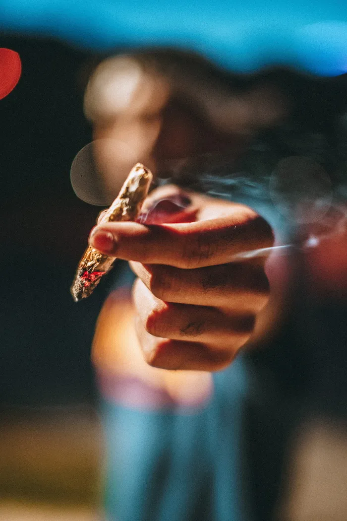 拿着发光的关节的人