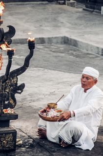坐在灰色混凝土路面上的男子