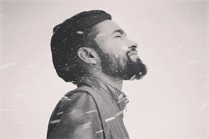 身穿拉链夹克的男子的灰度照片